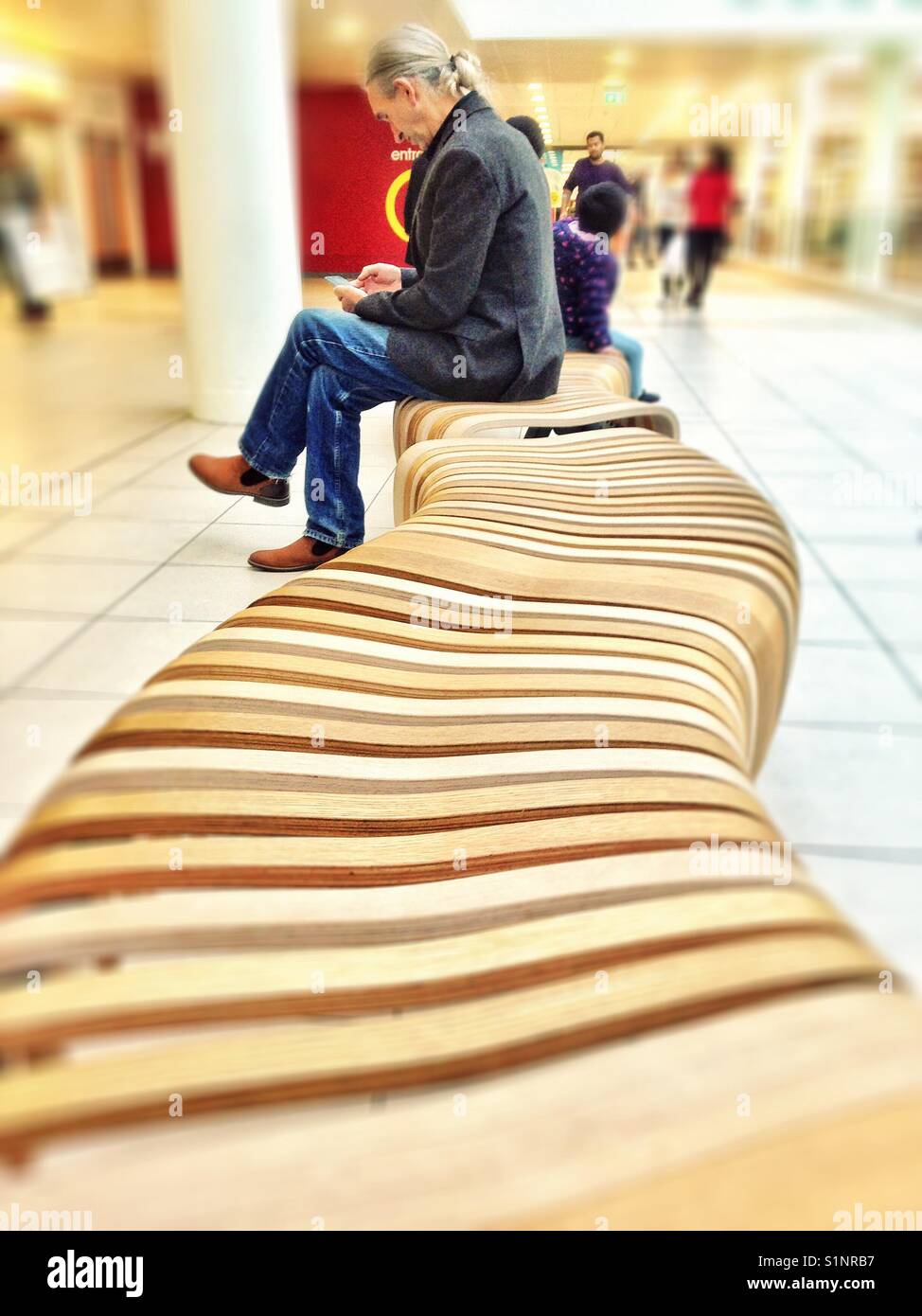 Man Sat On An S Shaped Bench Stock Photo 310880619 Alamy