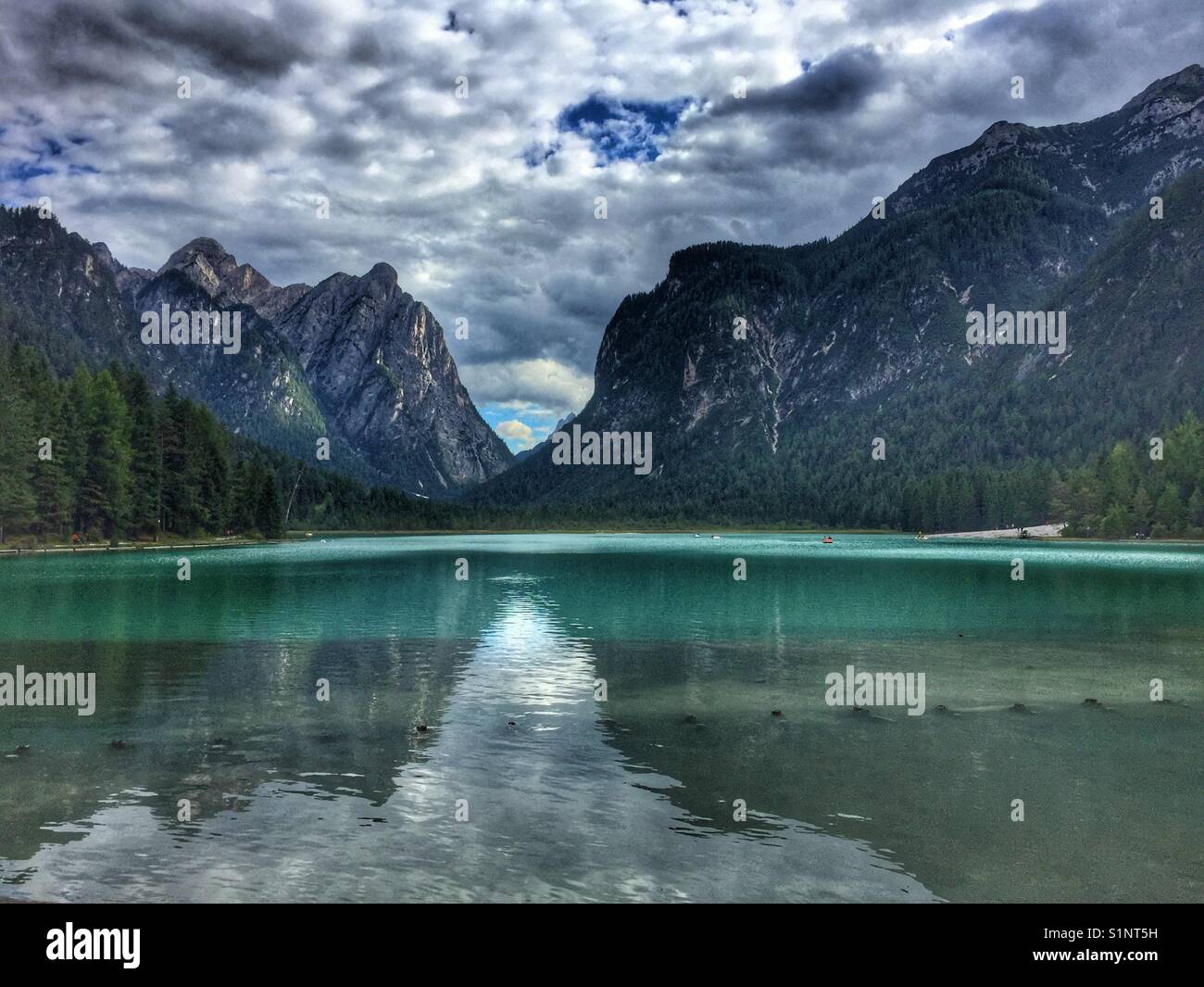 Mountain reflection on Dobbiaco Lake, Italy. - Smartphone Captured Stock Image