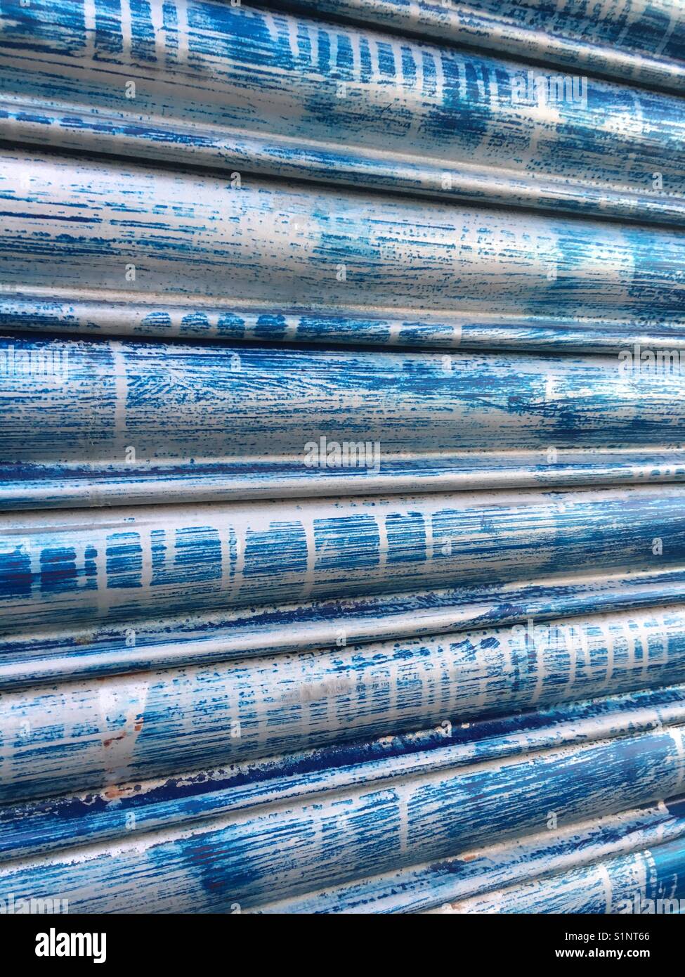 Spray painted blue corrugated metal door in London Stock Photo
