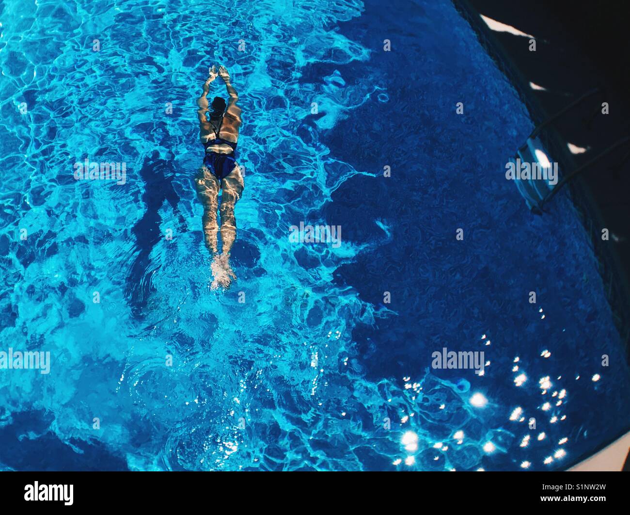 Woman swimming in the pool, photographed from above. - Smartphone Captured Stock Image