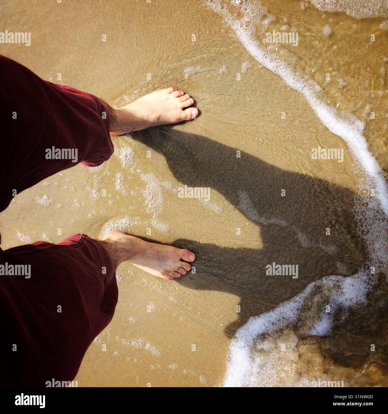 Person's feet on a beach sand - Smartphone Captured Stock Image