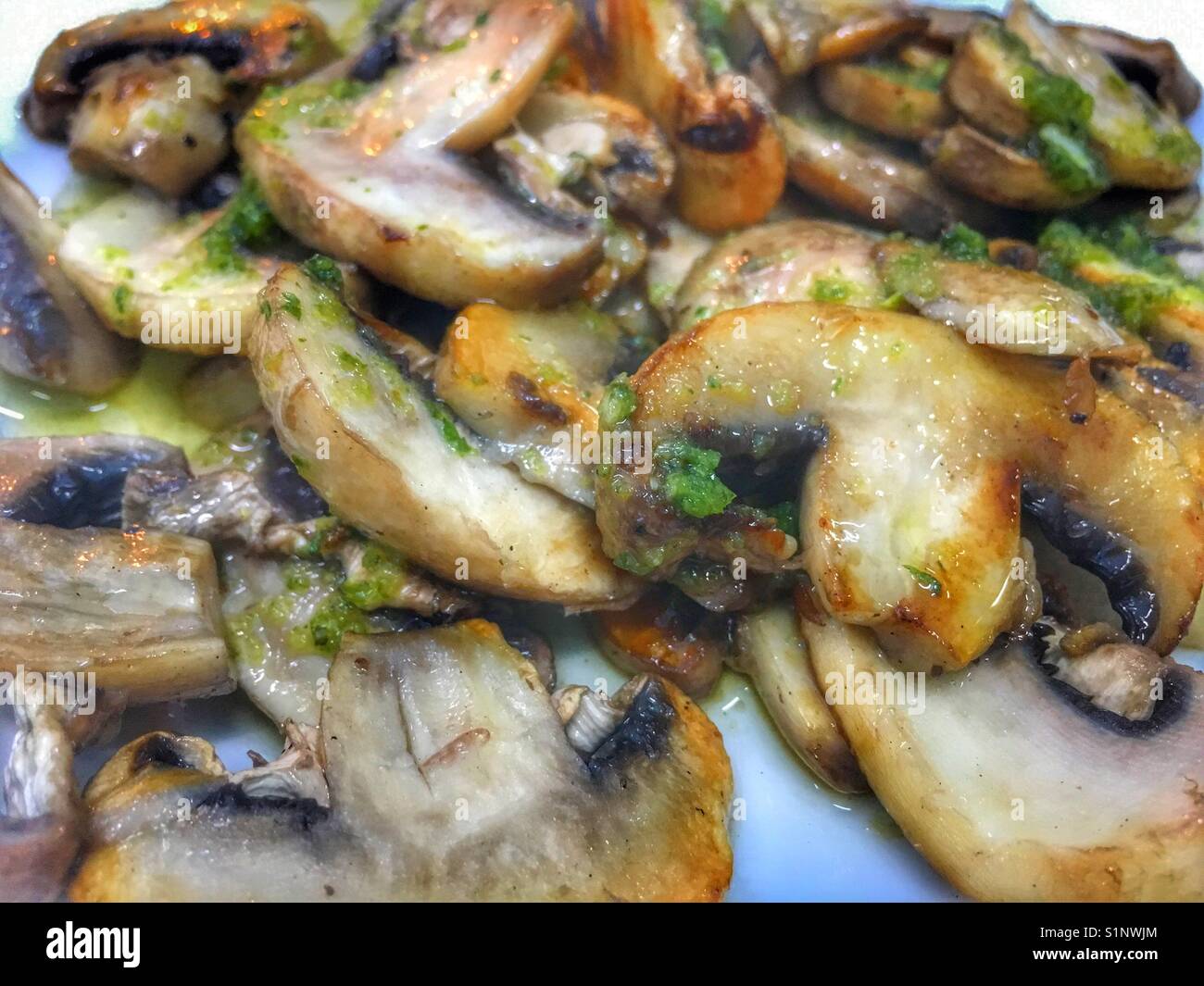 Spanish tapas. Mushrooms in olive oil and garlic Stock Photo Alamy