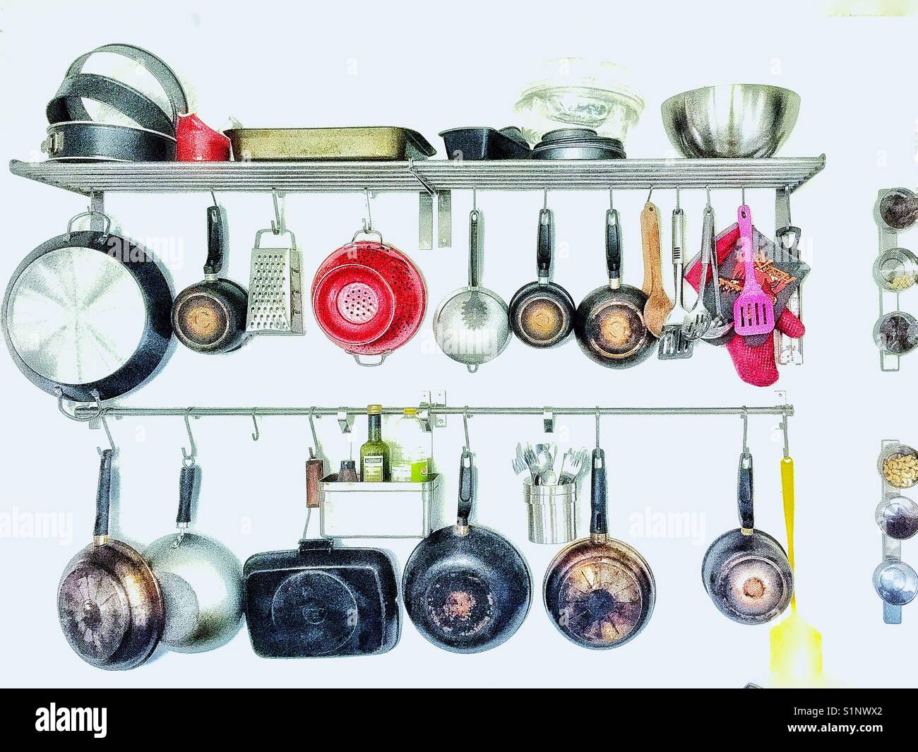 Kitchen utensils on a rack Stock Photo Alamy