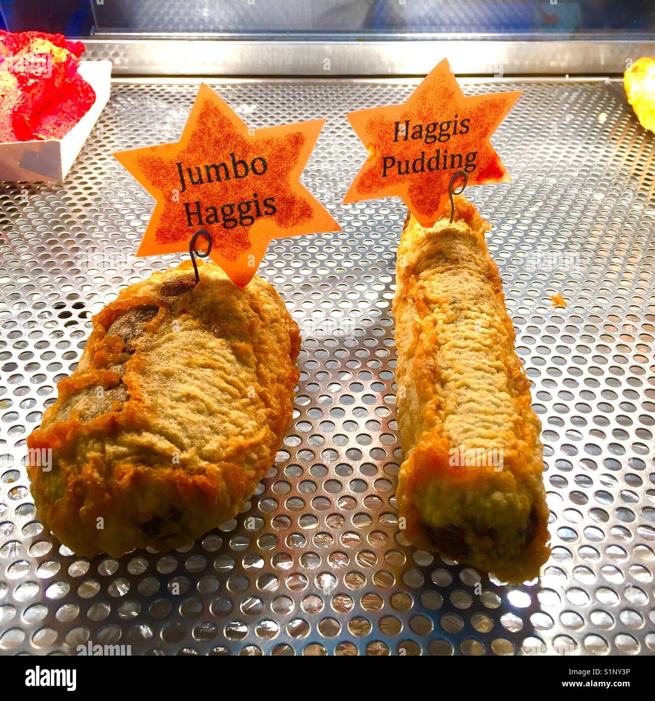 Fried haggis with display labels in a Scottish fish and chip shop take