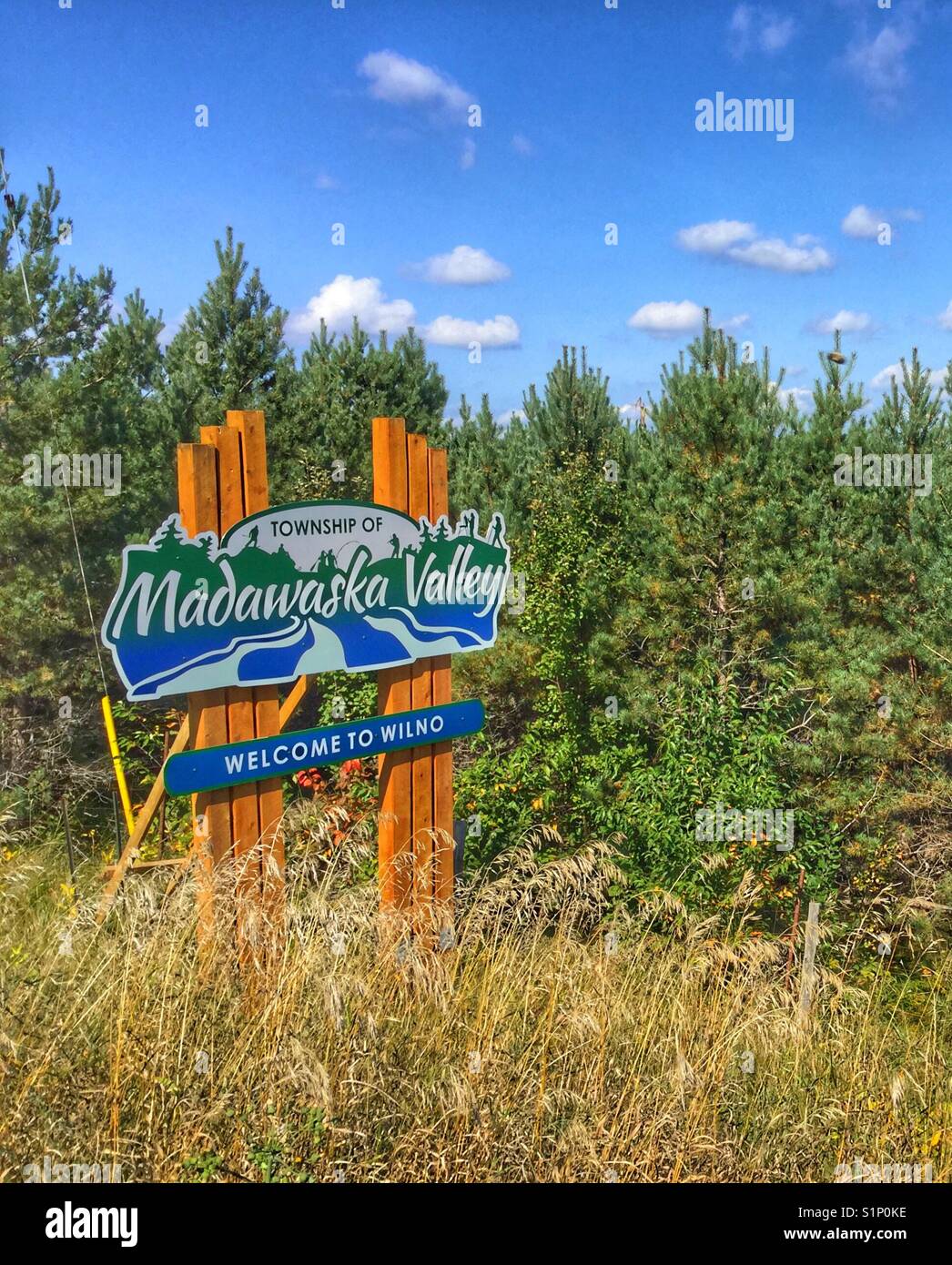 A wooden welcome roadside sign. Stock Photo