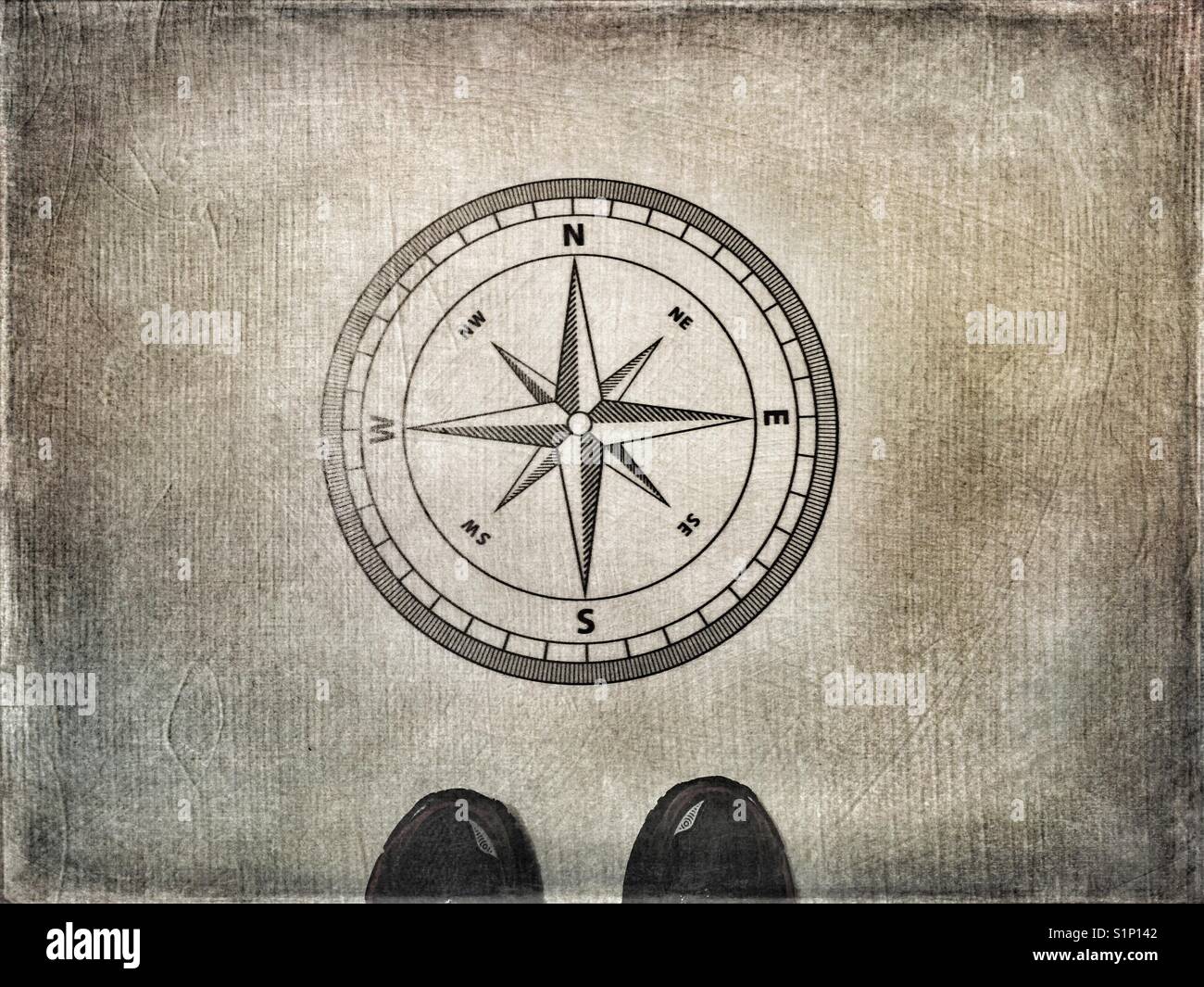 Person standing by navigational compass Stock Photo - Alamy
