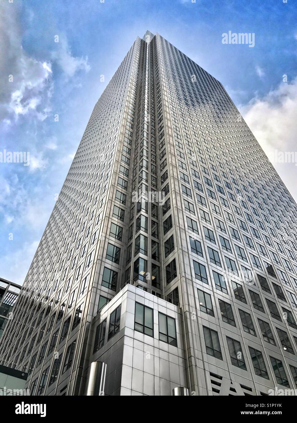 One Canada Square, Canary Wharf London Docklands. Looking up at striking modern architecture against blue sky. - Smartphone Captured Stock Image