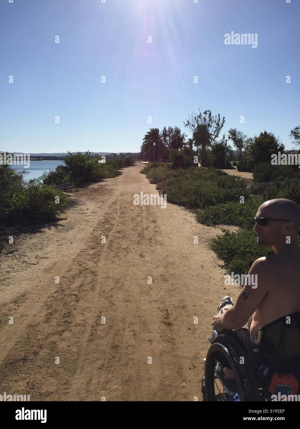 Going for an offroad walk in a wheelchair on San Diego bay Stock Photo