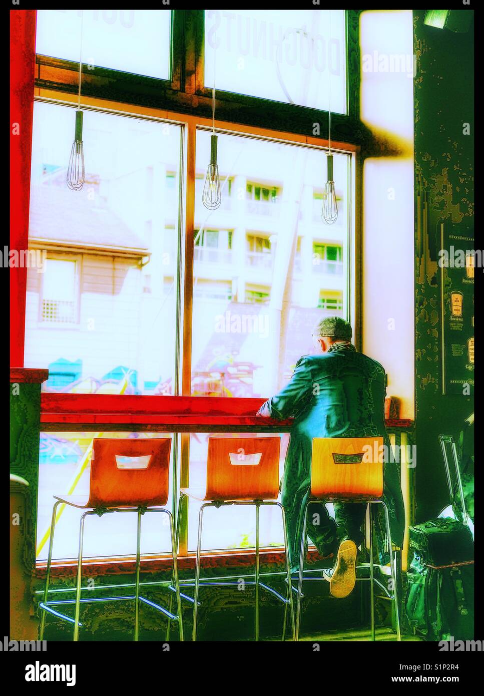 Man relaxing alone in cafe, Toronto, Canada - Smartphone Captured Stock Image