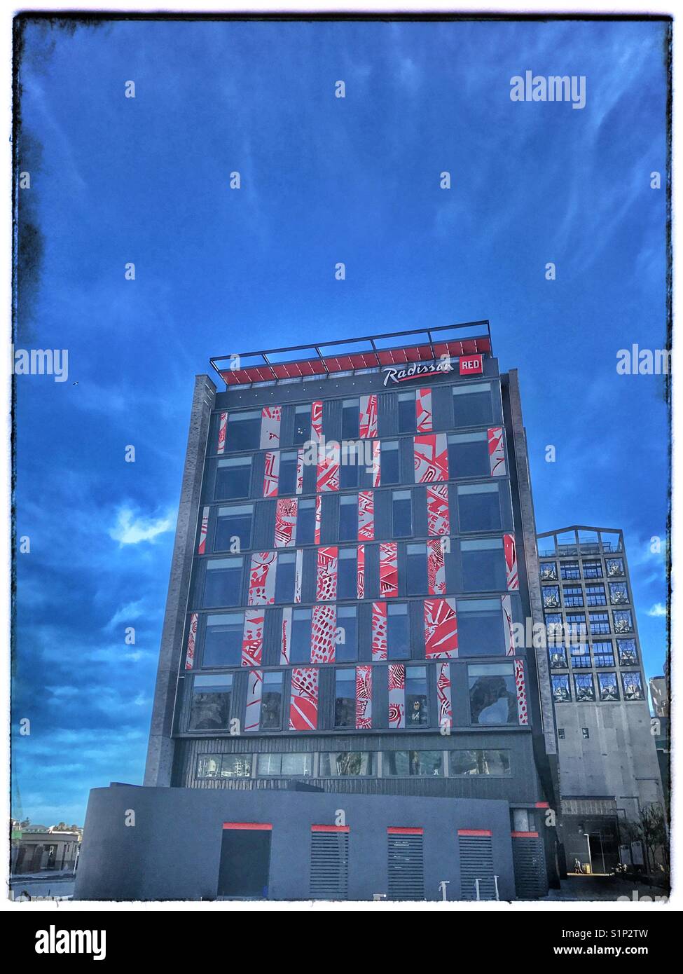 The Radisson Red Hotel in the Silo District of the V&A Waterfront with the Zeitz Museum in background. - Smartphone Captured Stock Image