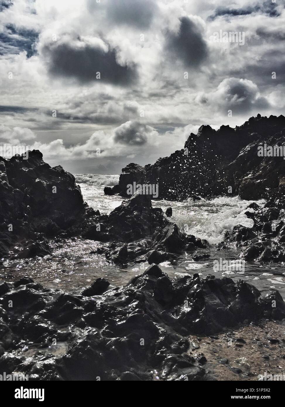 Crashing waves on rocks late afternoon in Rhosneigr - Smartphone Captured Stock Image