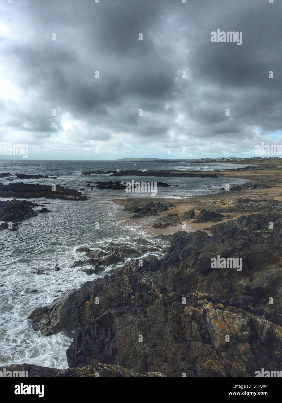 View from Lion Rock, Rhosneigr, Anglesey, across the beaches back to Rhosneigr village - Smartphone Captured Stock Image
