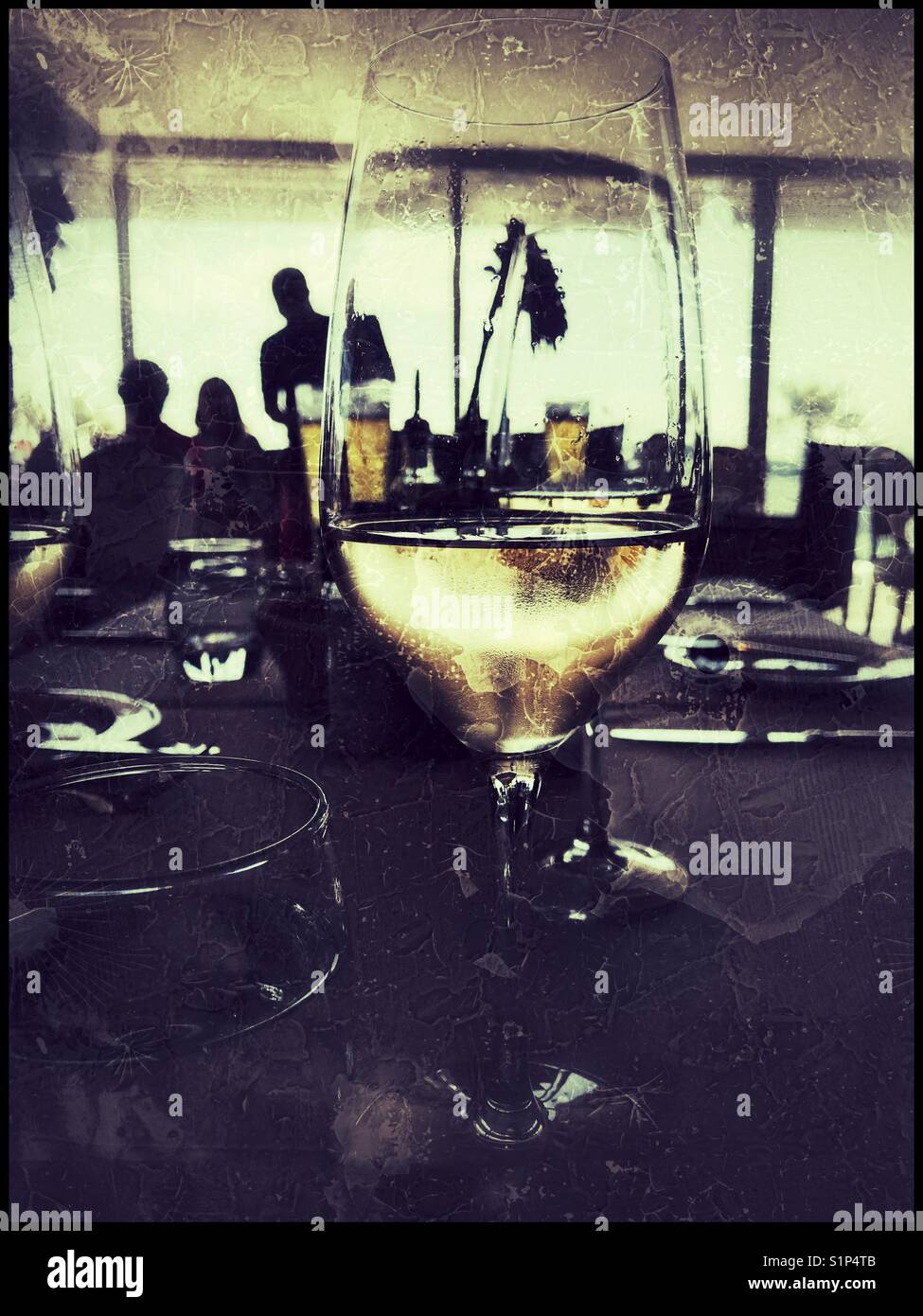 White wine glass on restaurant table. - Smartphone Captured Stock Image