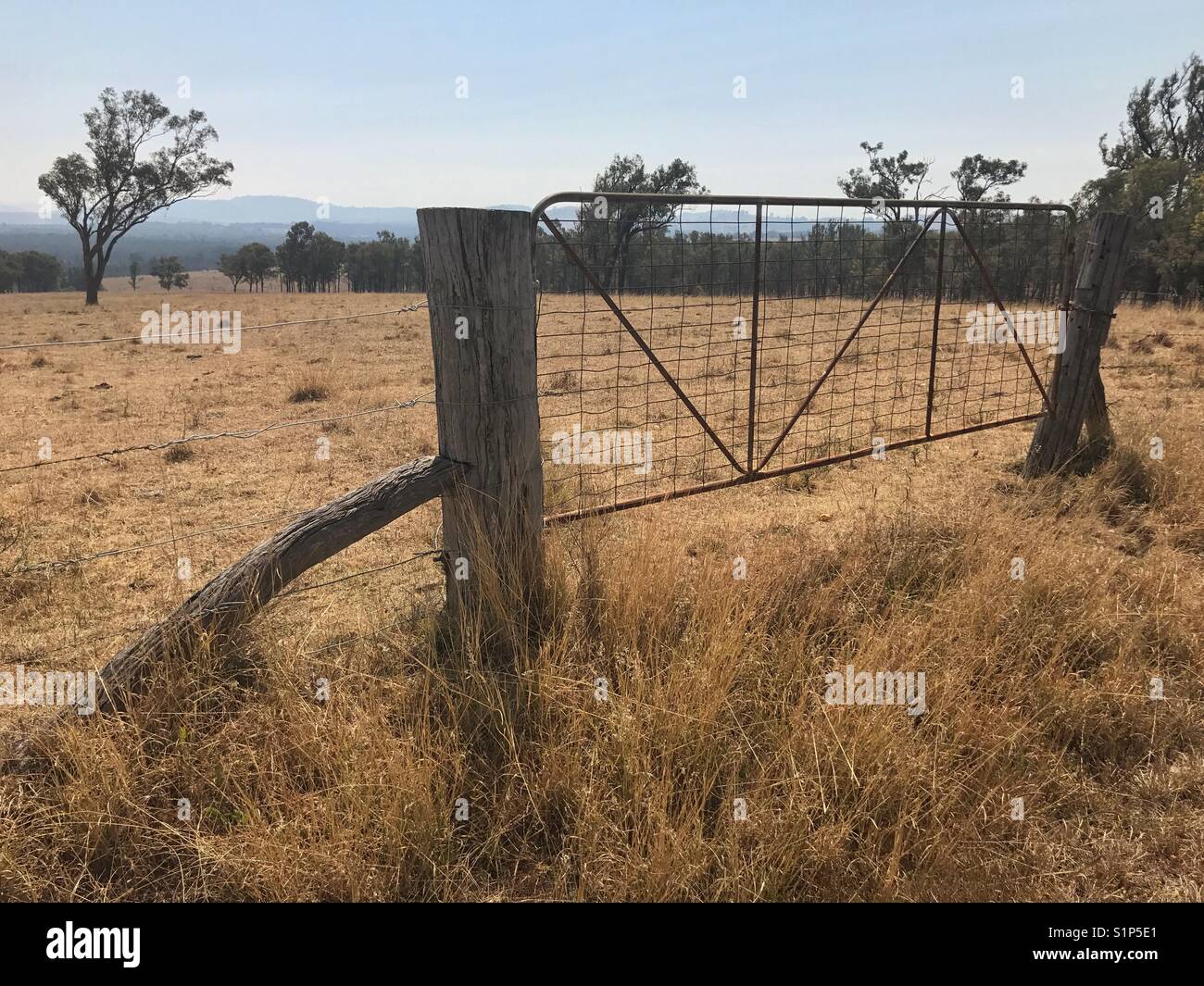 Rusty steel gate with worn timber posts - Smartphone Captured Stock Image