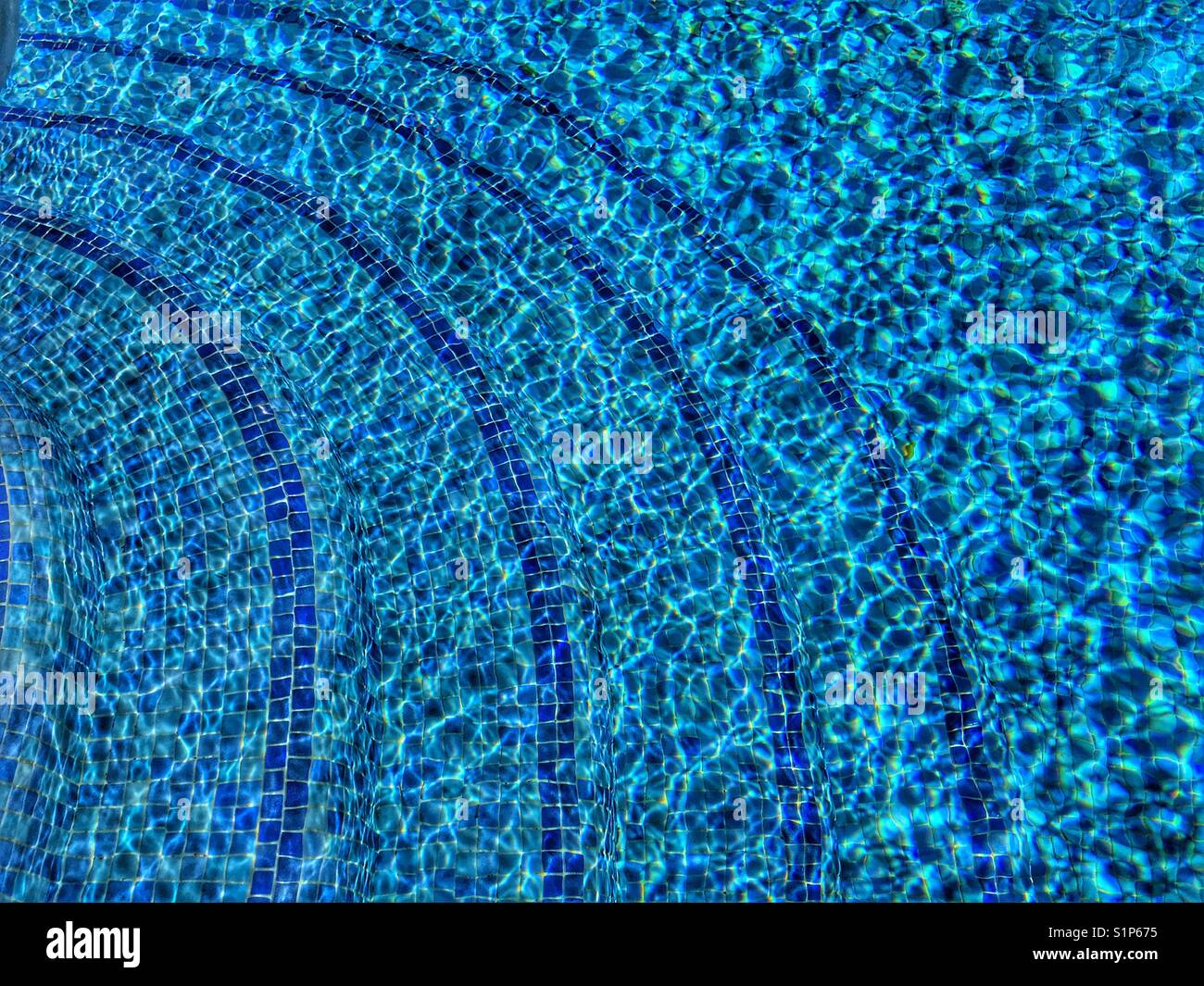 Swimming pool water, with light refraction on a sunny day - Smartphone Captured Stock Image