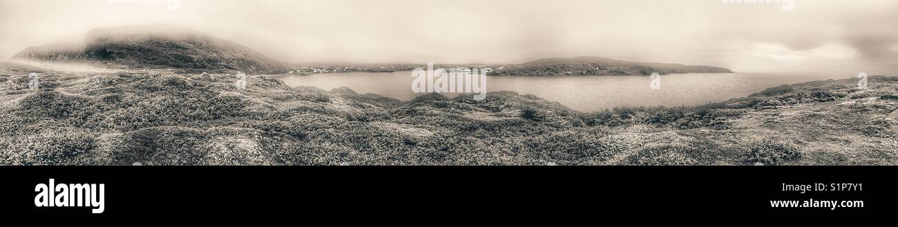 Misty atmospheric panorama of St Anthony, Great Northern Peninsula, Newfoundland, Canada - Smartphone Captured Stock Image