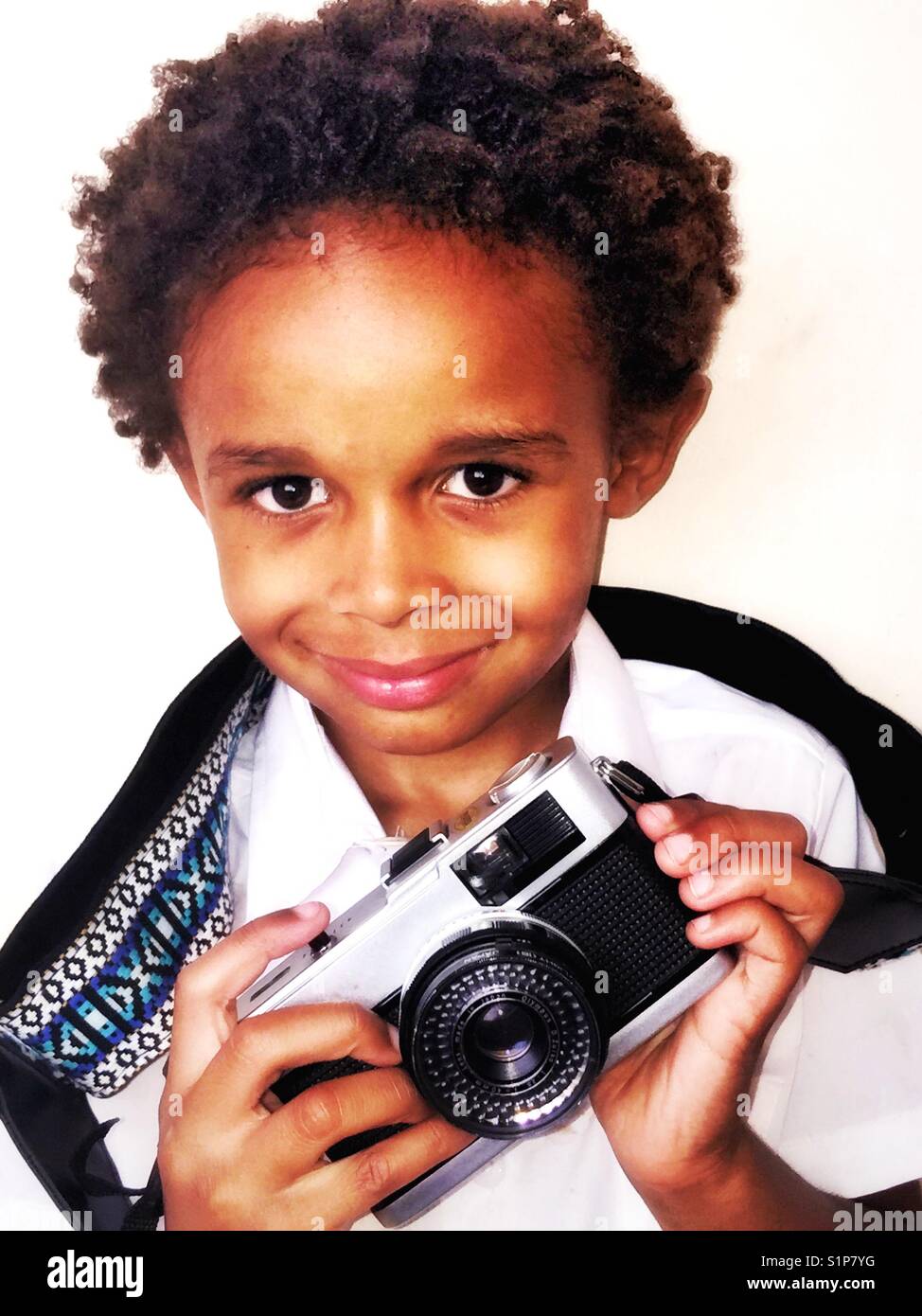 Smiling boy with a vintage, retro camera. - Smartphone Captured Stock Image