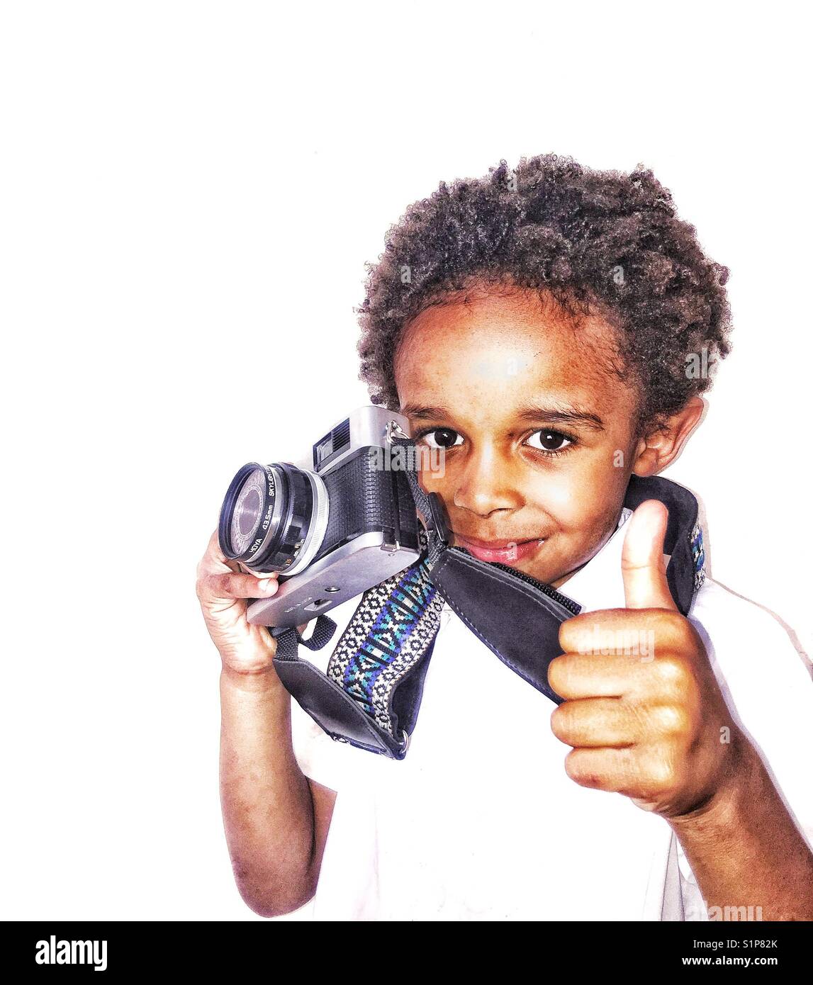 Are young boys holding a vintage camera gives a thumbs  up sign. Stock Photo