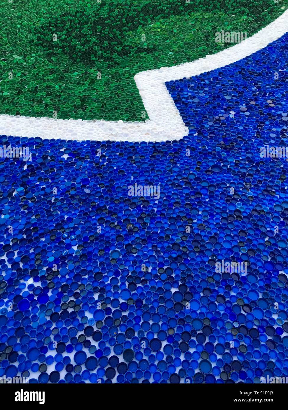 A detail of a big mosaic made of plastic bottle tops for Guinness record in Novi Sad in Serbia in Europe - Smartphone Captured Stock Image