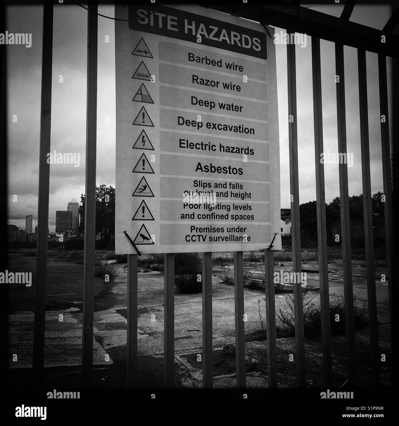 Hazard sign with Canary Wharf in the background Stock Photo
