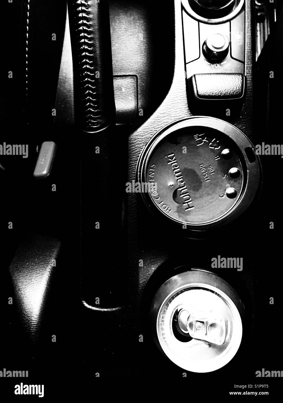 Coffee cup and soft drink can in car cup holders Stock Photo - Alamy
