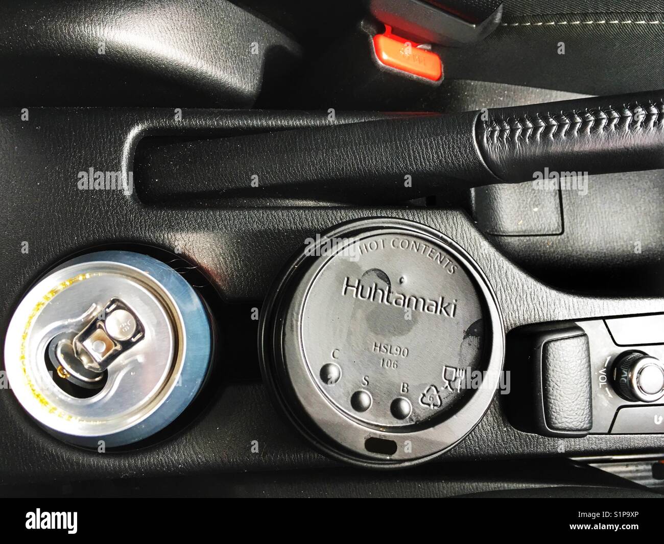 Coffee and soft drink can in car cup holders - Smartphone Captured Stock Image