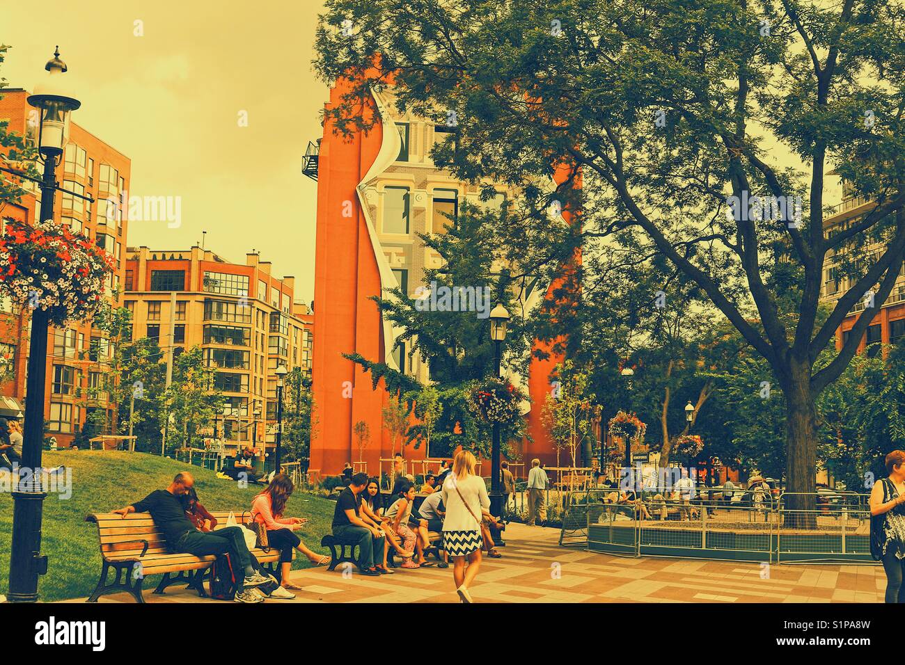 People relaxing in Berczy Park, Toronto, Ontario, Canada - Smartphone Captured Stock Image