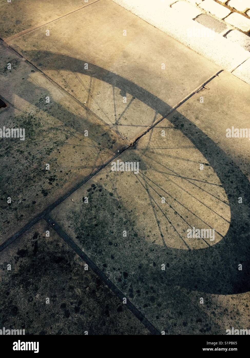 Shadow of a bike wheel Stock Photo