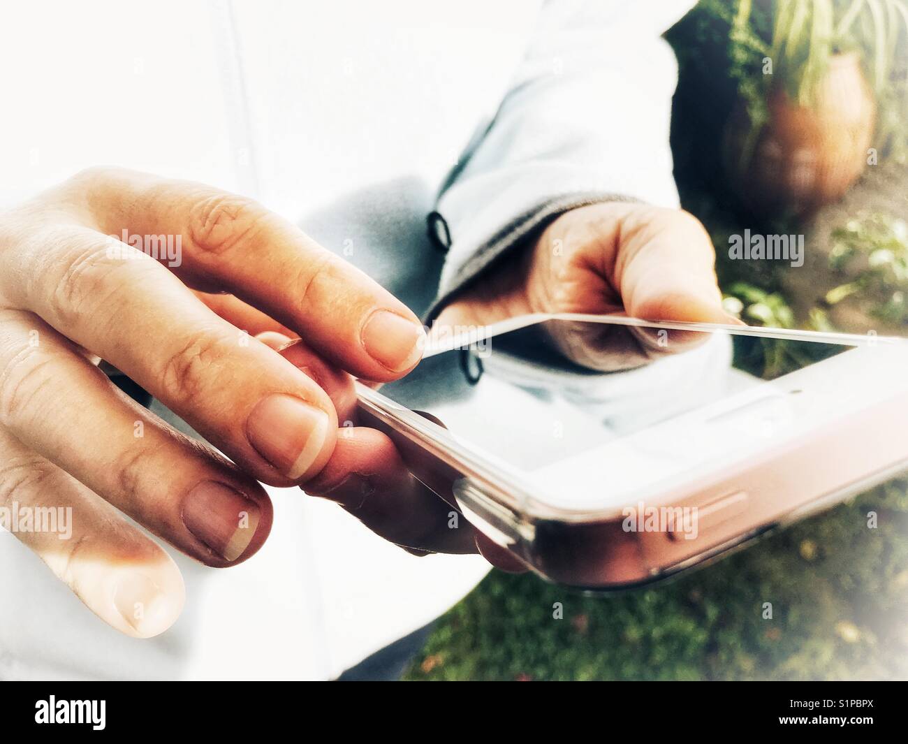 Woman using smartphone, outdoors - Smartphone Captured Stock Image