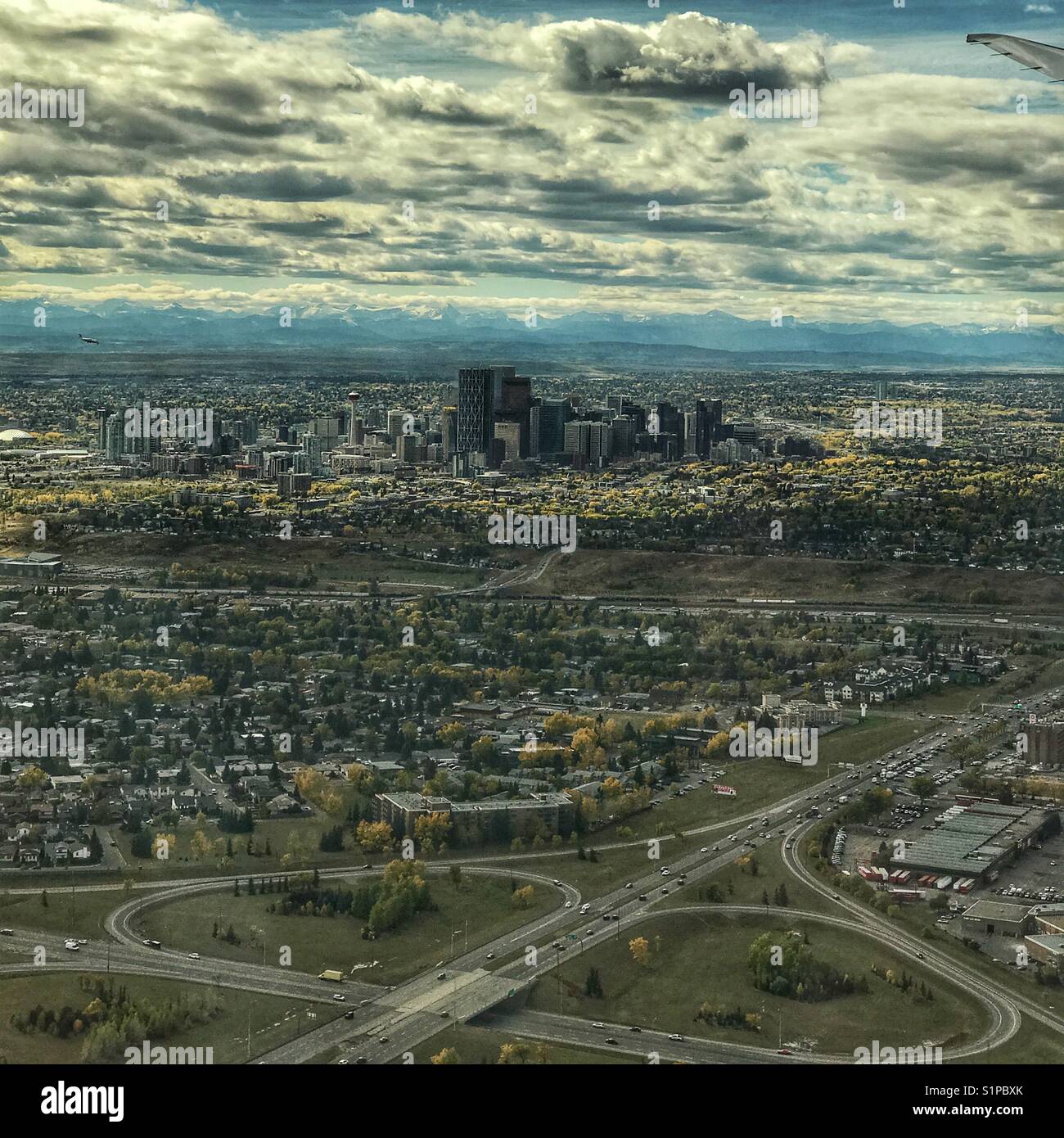 Downtown core of the city of Calgary, with Rocky mountains in the background, as viewed from a plane about to land. Alberta, Canada. Stock Photo
