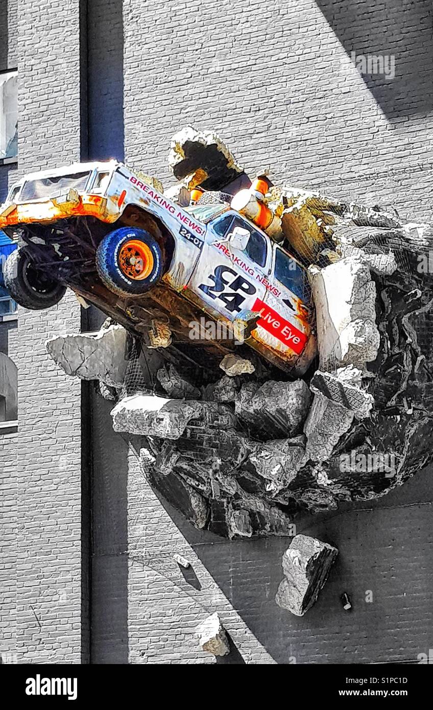 Sculpture of news truck breaking out of wall, CTV (City TV) building (1913), Queen Street West, Toronto, Ontario, Canada - Smartphone Captured Stock Image