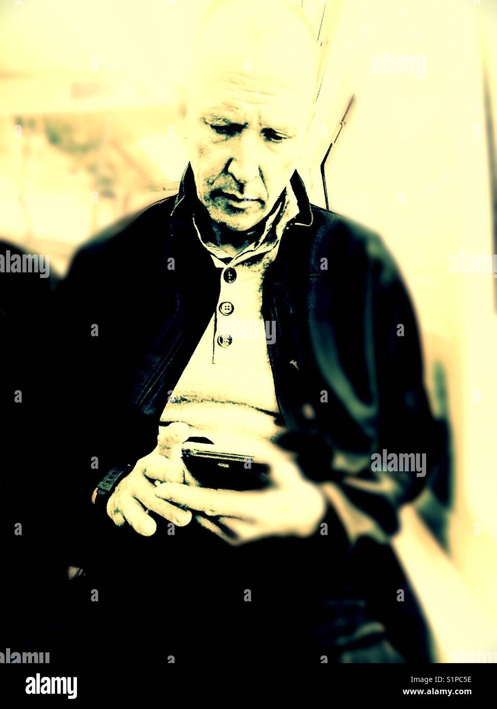 Middle aged Scandinavian man using smartphone on train, Sweden - Smartphone Captured Stock Image