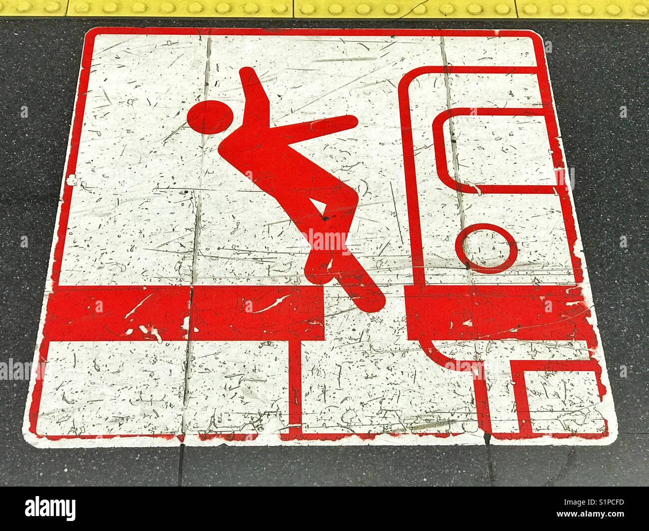 A warning sign on the floor of the Madrid Metro Rail System - beware of the gap between platform and train. It could be a hazard! A public information image. Photo Credit - © COLIN HOSKINS. - Smartphone Captured Stock Image