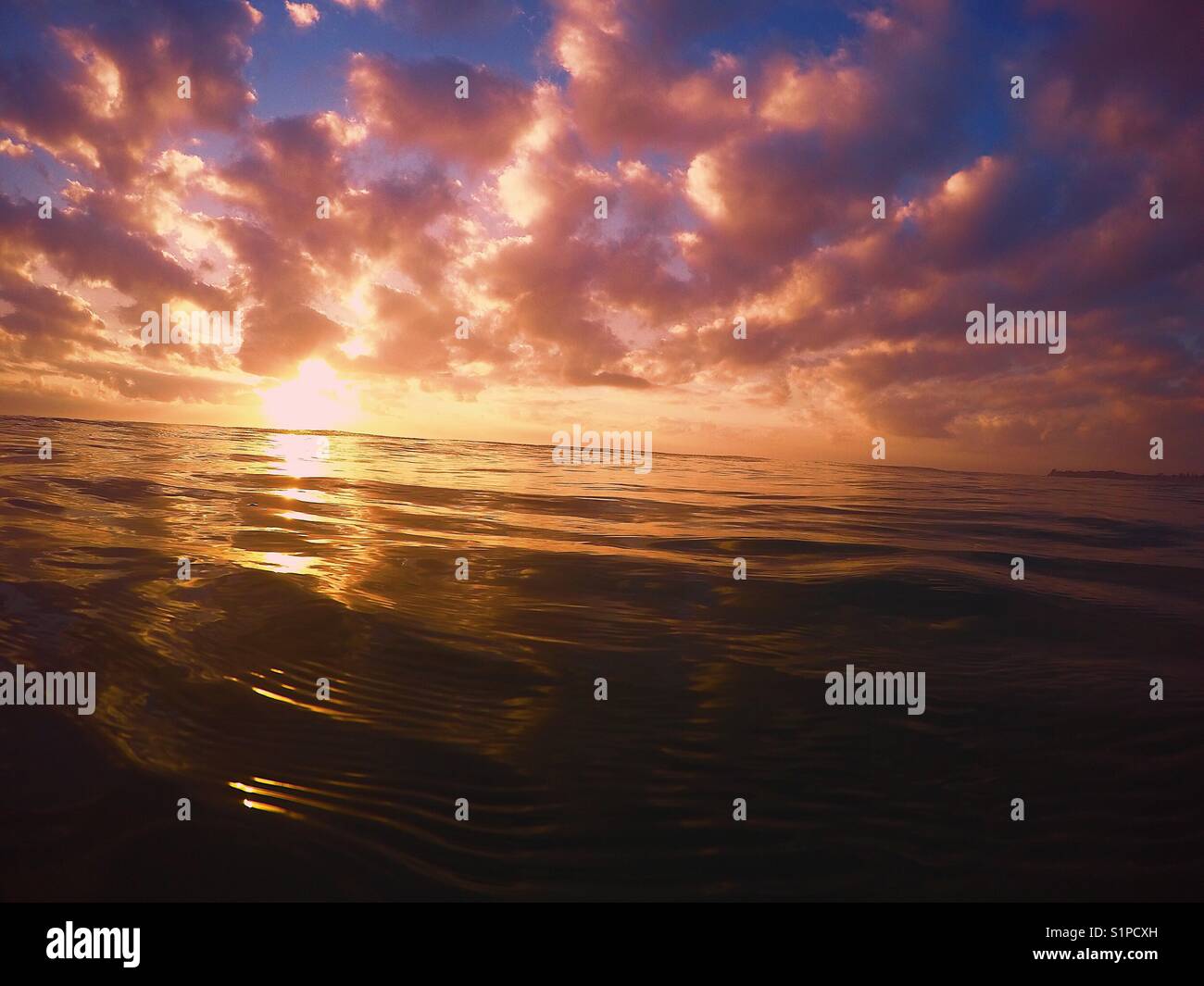Orange cloudy ocean sunrise sky Stock Photo - Alamy
