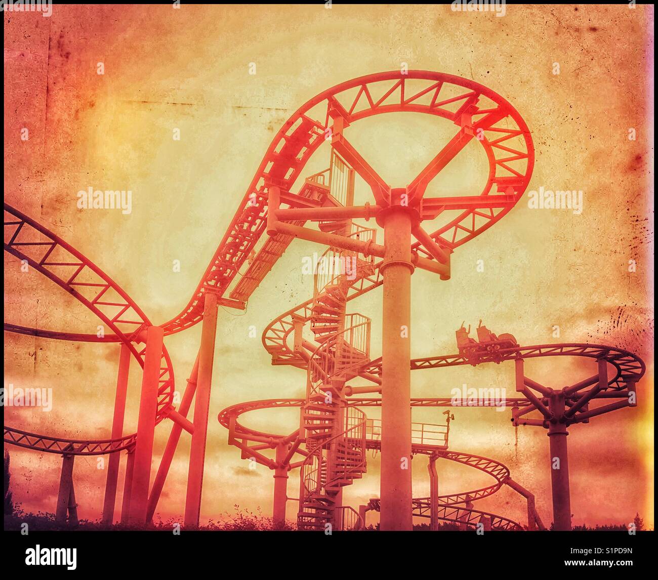 A retro effect image of children riding on a rollercoaster ride. Their hands are in the air- it's great fun! Photo Credit - © COLIN HOSKINS. - Smartphone Captured Stock Image