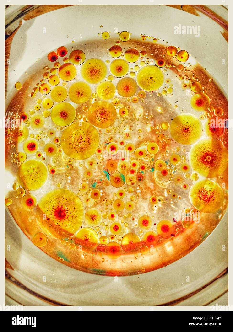 Oil and food colouring suspended in water. Stock Photo