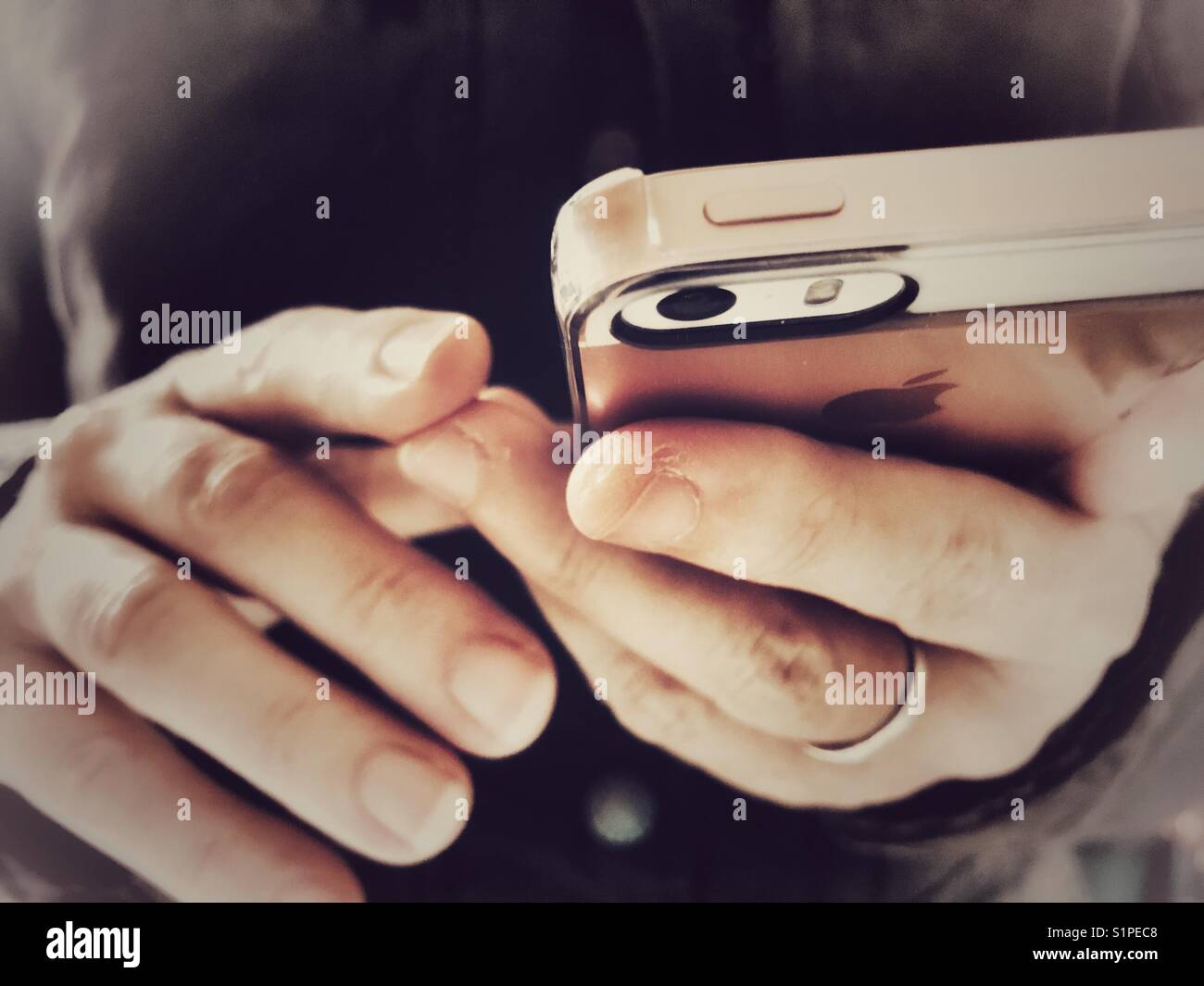 Wireless technology. Woman using an iPhone. Mid section, close-up of phone in hands. - Smartphone Captured Stock Image