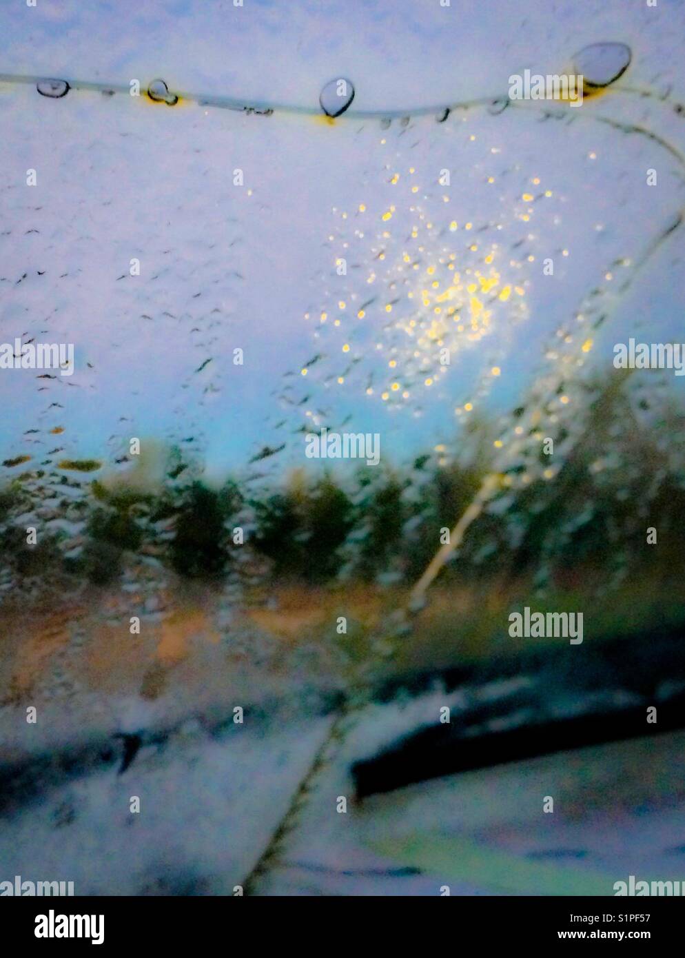 Harvest moon morning through dewy, cracked windshield - Smartphone Captured Stock Image