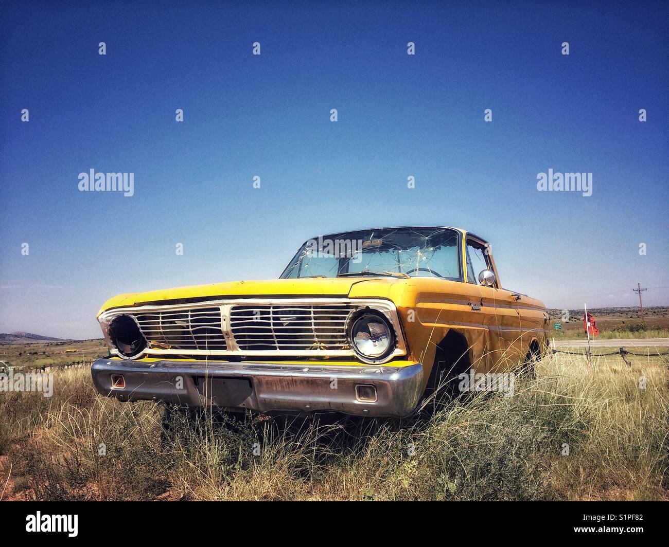Old and rusty Ford car on route 66, California, USA Stock Photo
