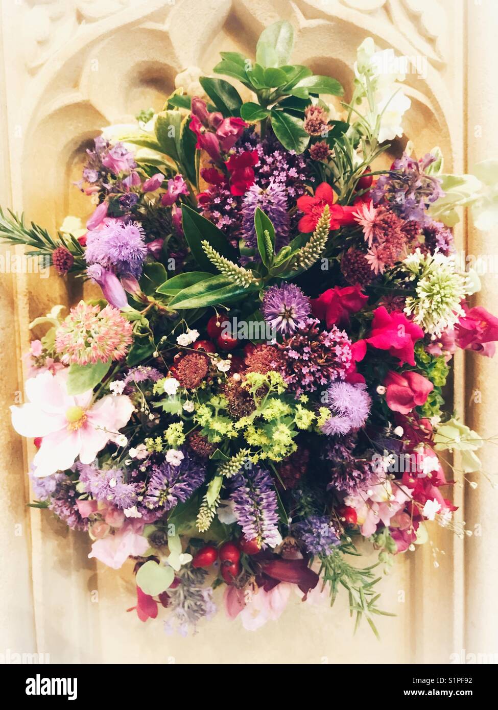 Flower arrangement in a church decorated for the Harvest Festival. - Smartphone Captured Stock Image