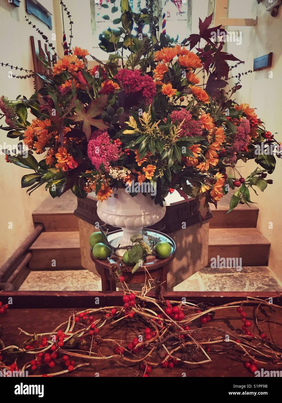 Flower and fruit arrangement in a church decorated for the Harvest Festival. - Smartphone Captured Stock Image
