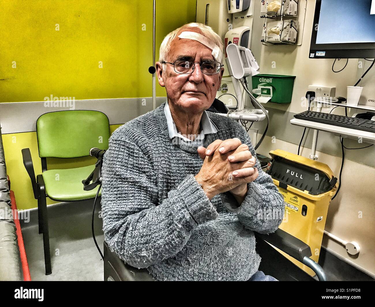 Senior man in A&E in hospital with a head injury, waiting to be assessed by the doctor. - Smartphone Captured Stock Image