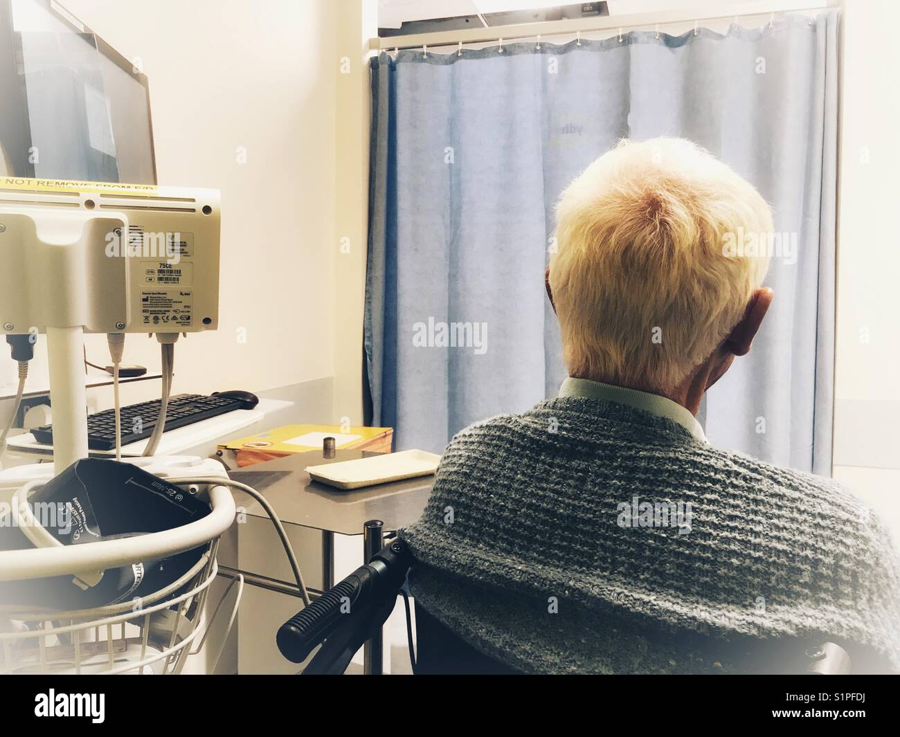 Senior man in A&E in hospital, waiting to be assessed by the doctor. - Smartphone Captured Stock Image