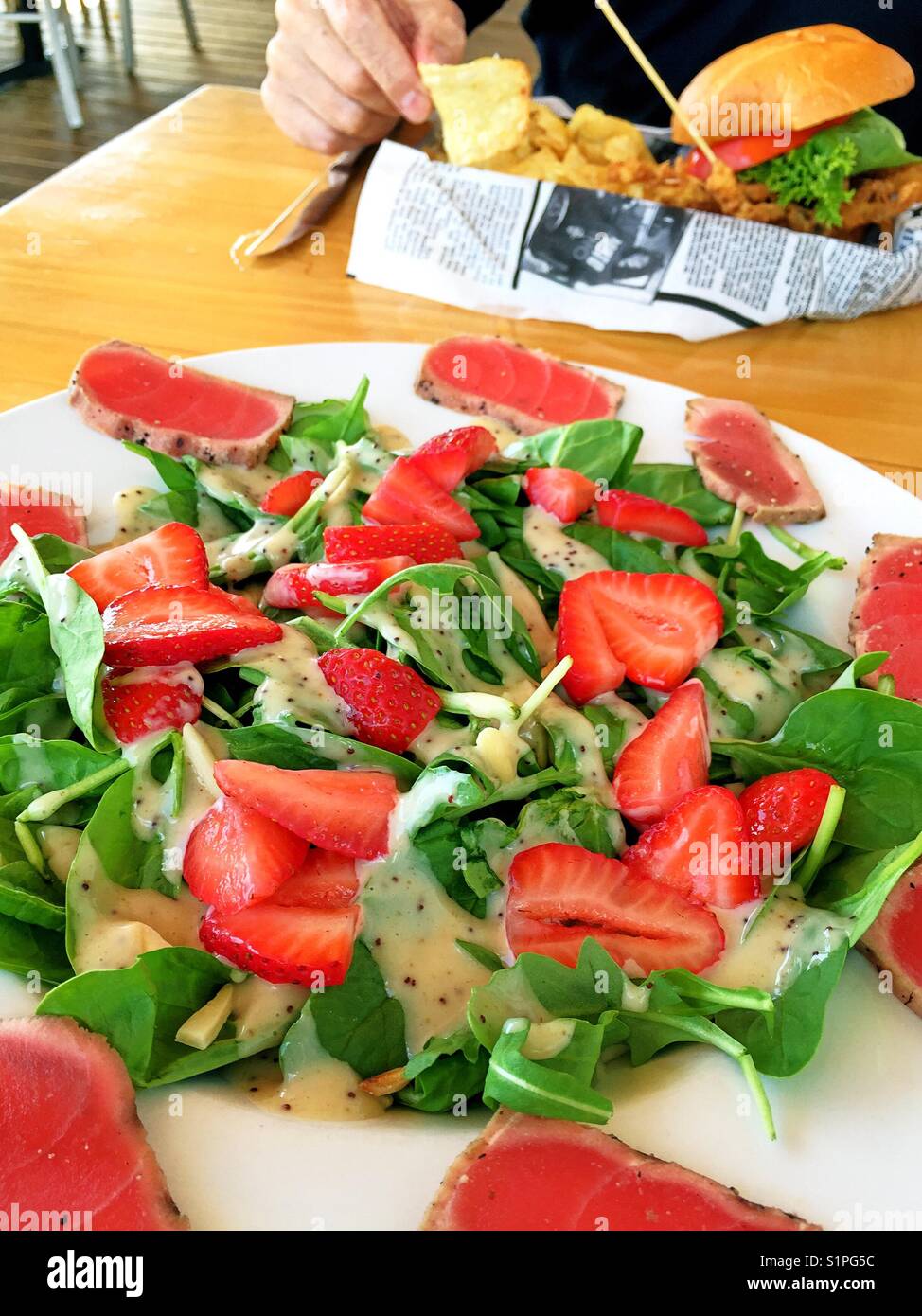 Maincourse salad of seared tuna strawberries and spinach, seafood restaurant, USA - Smartphone Captured Stock Image
