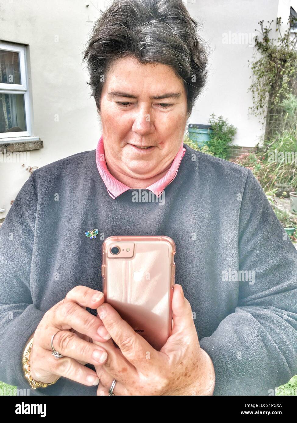 Woman taking a photo on an iPhone - Smartphone Captured Stock Image