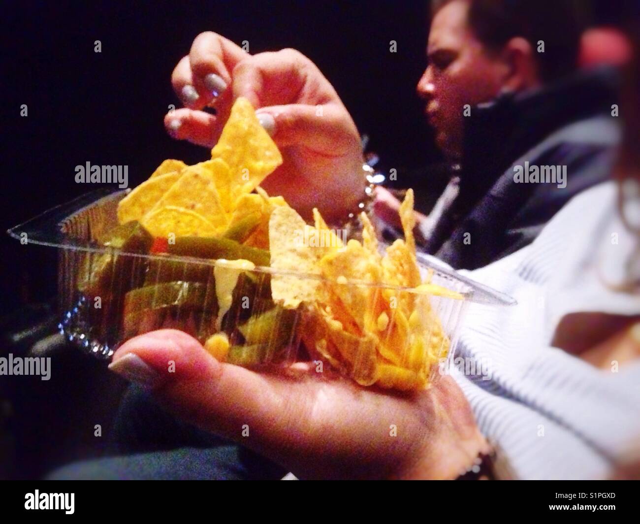 Eating Nachos At The Cinema Stock Photo Alamy