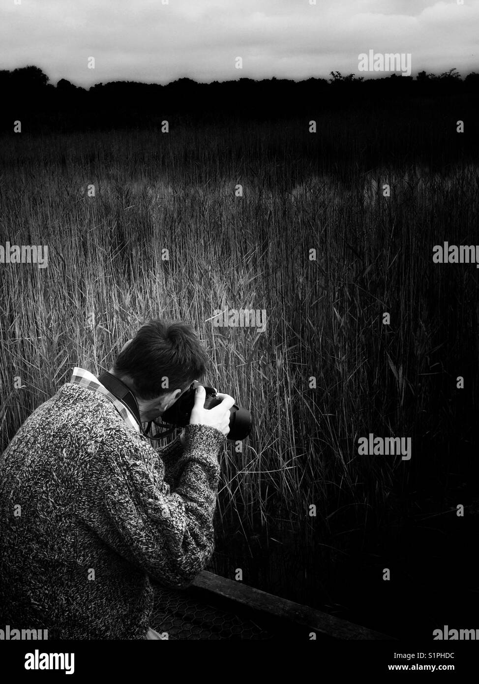 Man taking photographs at a nature park in black and white Stock Photo
