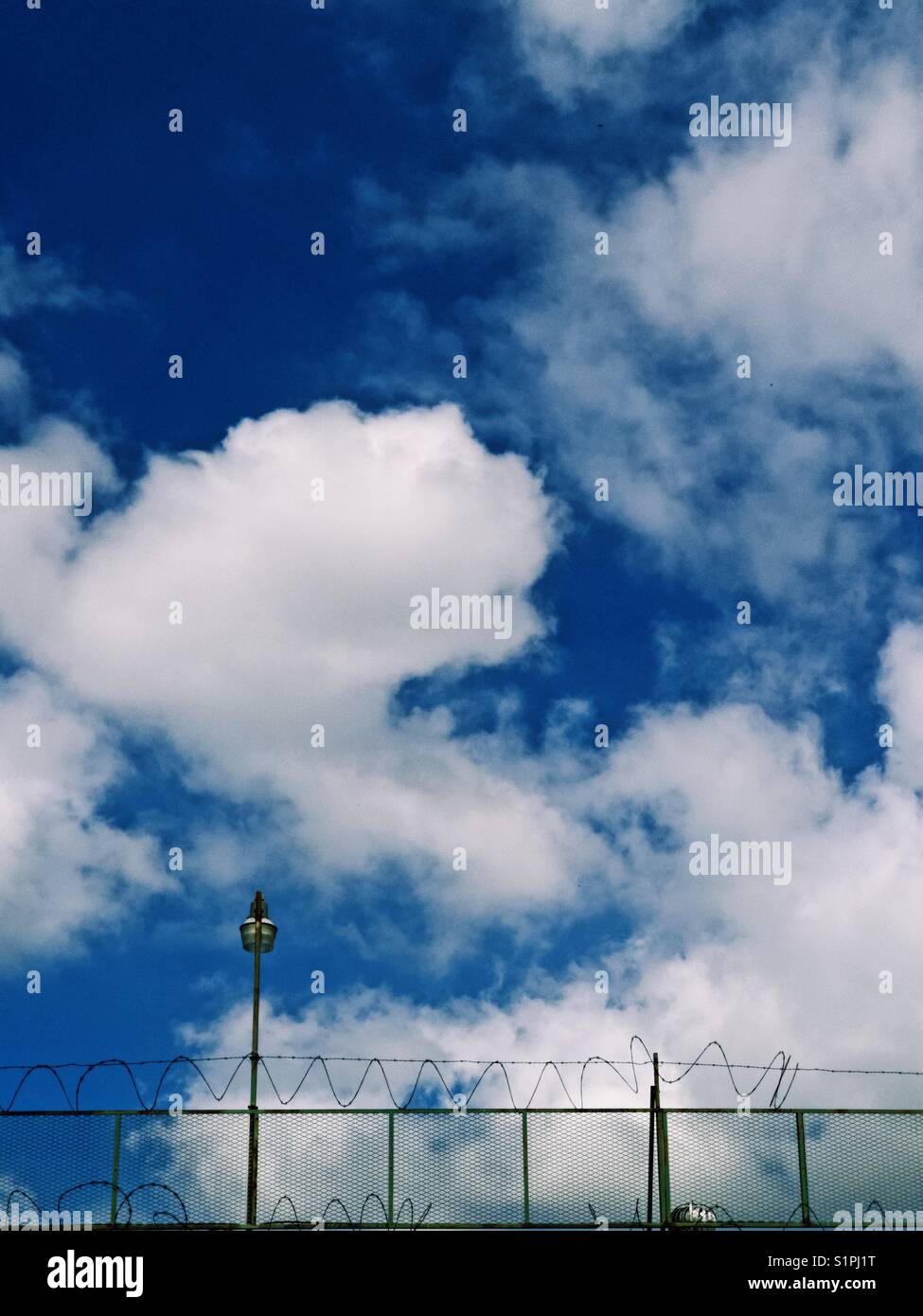 Security camera on the rooftop of a warehouse in a mixed commercial industrial neighborhood in Brooklyn - Smartphone Captured Stock Image