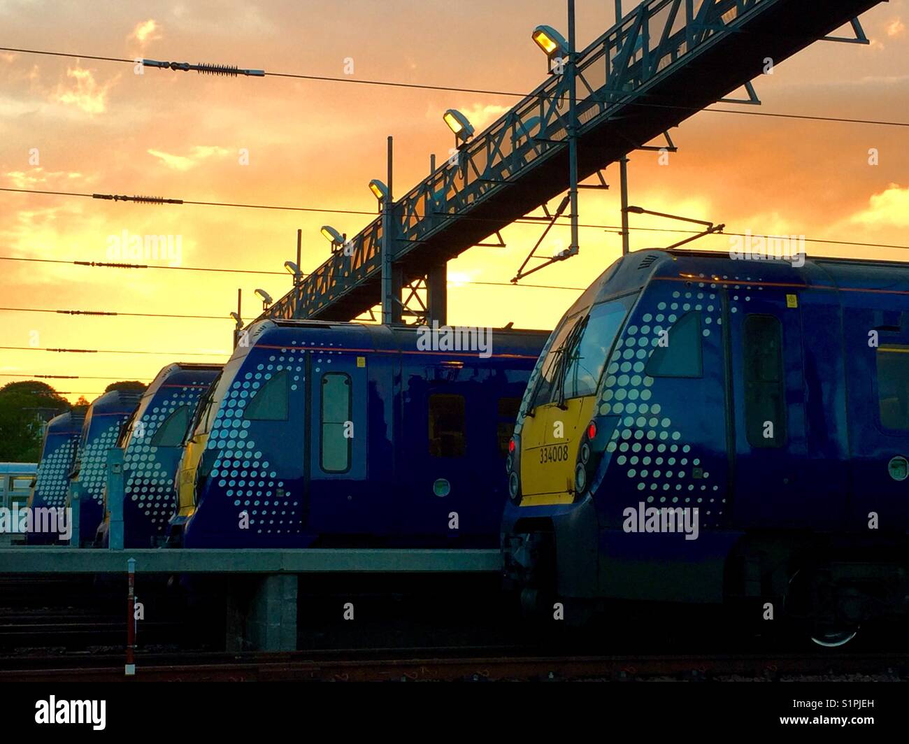 Trains parked in depot at sunset - Smartphone Captured Stock Image