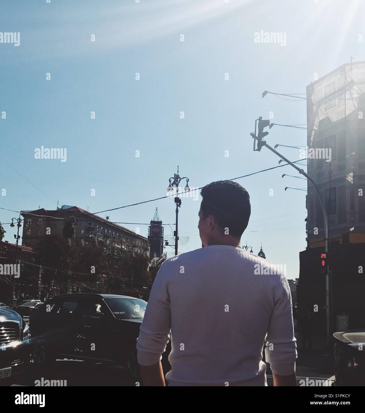 A tourist out on a sunny day in the streets of Kiev City, Ukraine - Smartphone Captured Stock Image